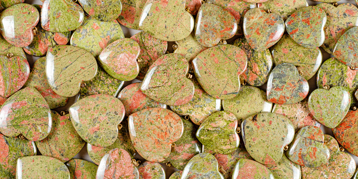 A photo of polished heart-shaped Unakite Jasper.
