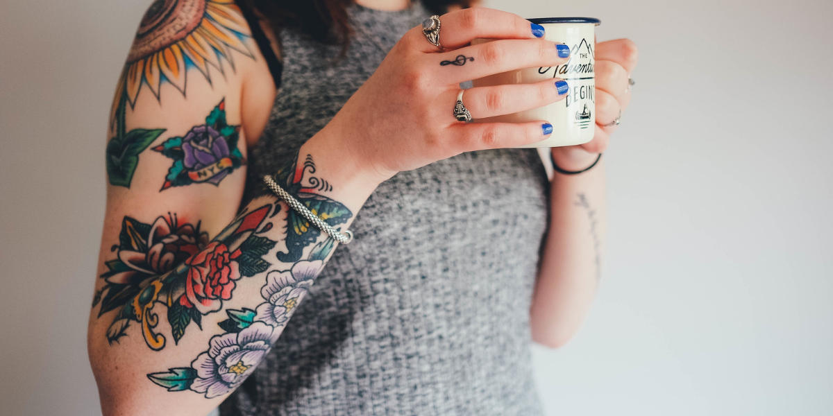 A person with tattoos on their arm