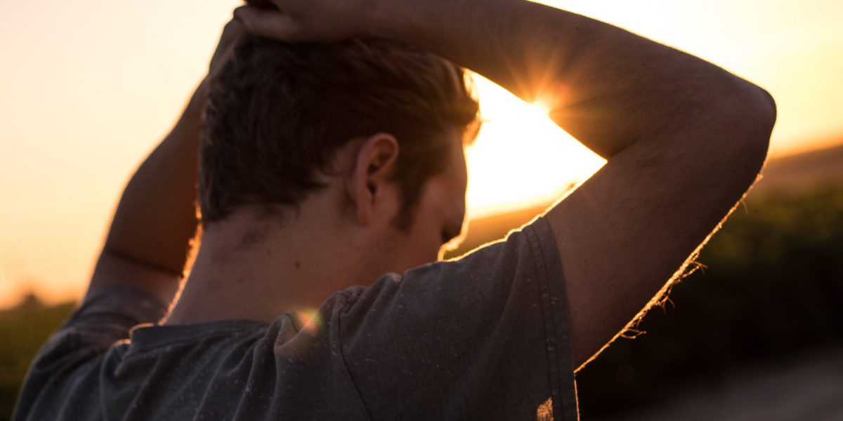 A man with his hands on his head, in thought.